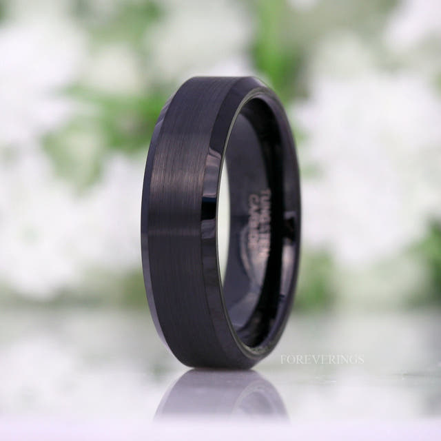 Brushed black tungsten men's ring standing upright, wider view