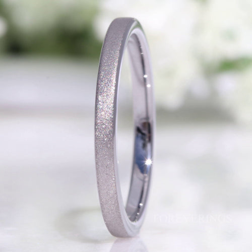 Women's 2mm flat silver tungsten band with a sparkling sandblasted finish, standing upright