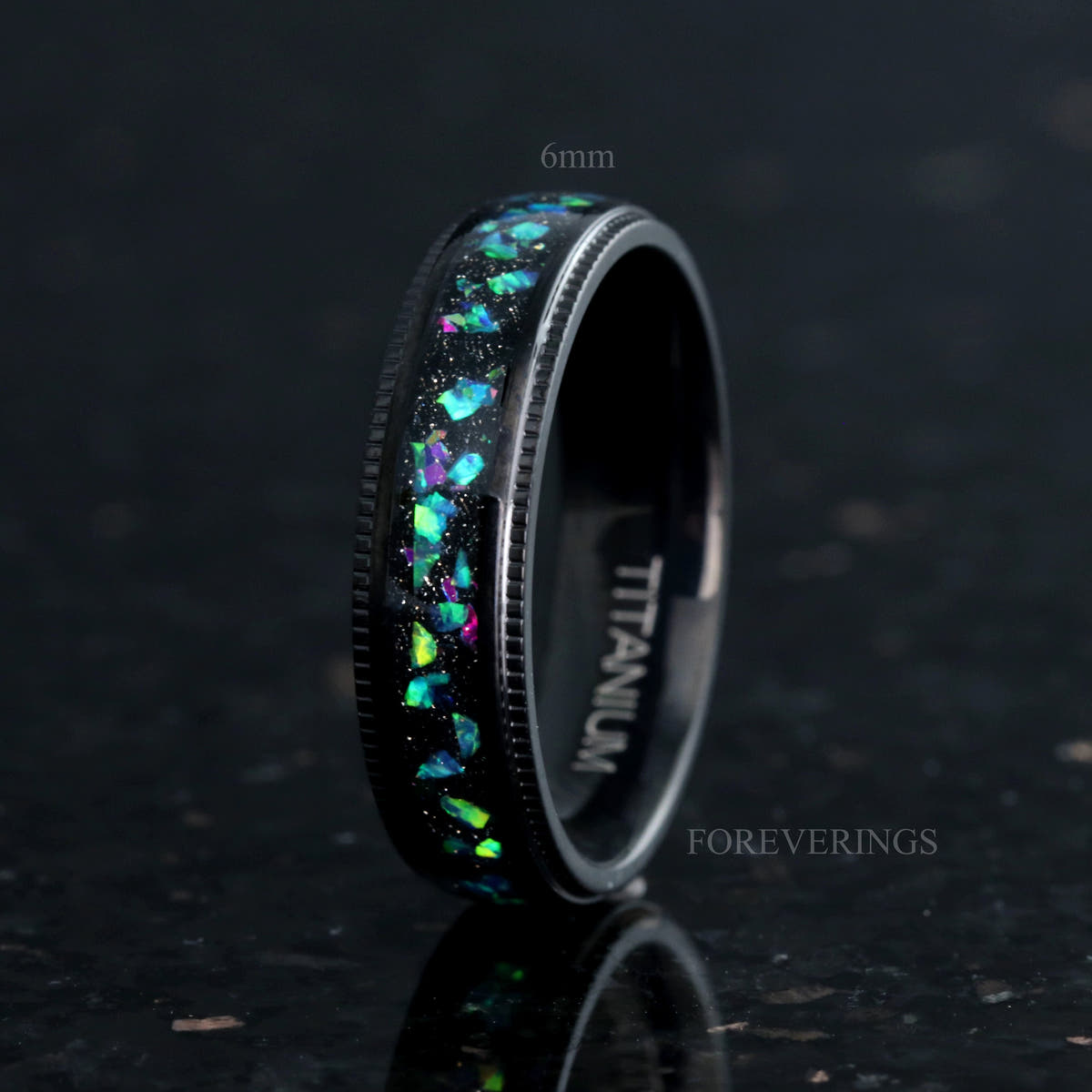 6mm black titanium ring with galaxy opal inlay and milgrain edges, standing at an angle