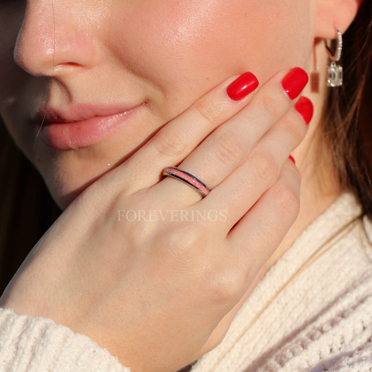 Women's 4mm silver tungsten ring with pink fire opal inlay, worn on a hand