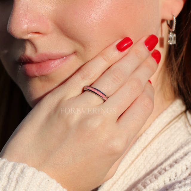 Women's 4mm silver tungsten ring with pink fire opal inlay, worn on a hand