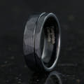 Men's 7mm hammered black tungsten band with an offset groove, standing at an angle