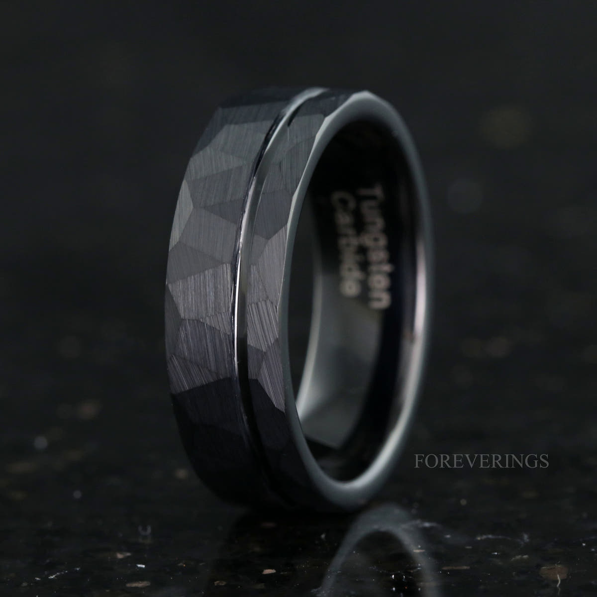 Men's 7mm hammered black tungsten band with an offset groove, standing at an angle