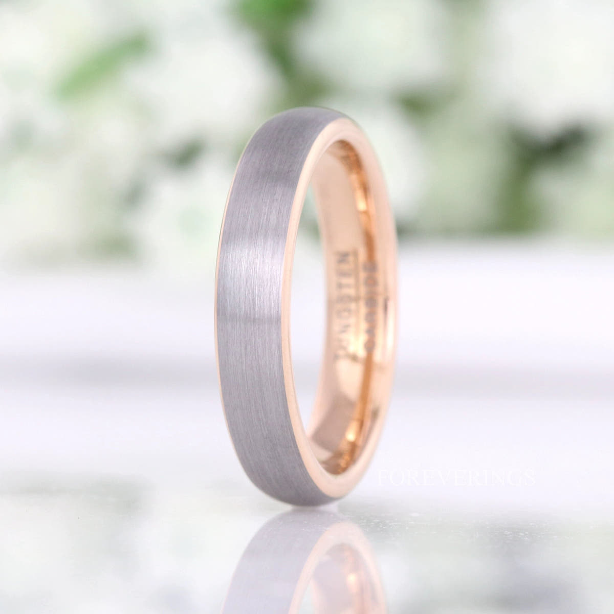 4mm two-tone silver and rose gold tungsten band standing on edge, the 4mm width