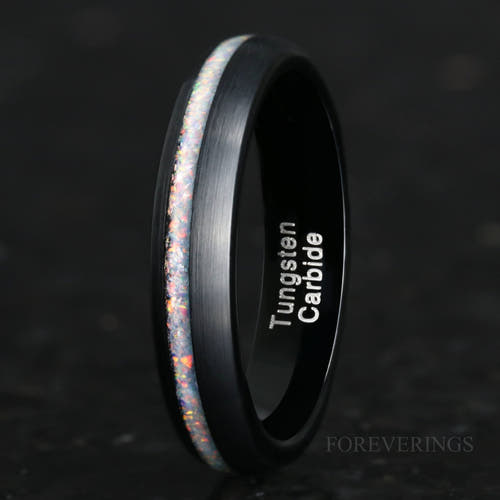 4mm brushed black tungsten ring with a white fire opal stripe, standing at an angle