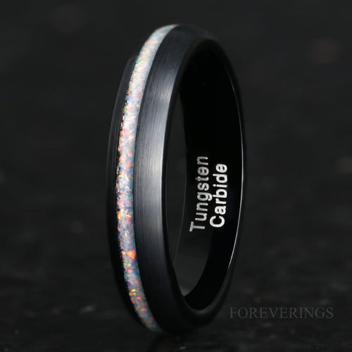 4mm brushed black tungsten ring with a white fire opal stripe, standing at an angle