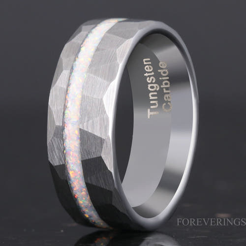 Men's hammered silver tungsten ring with a white fire opal stripe, angled to show the interior