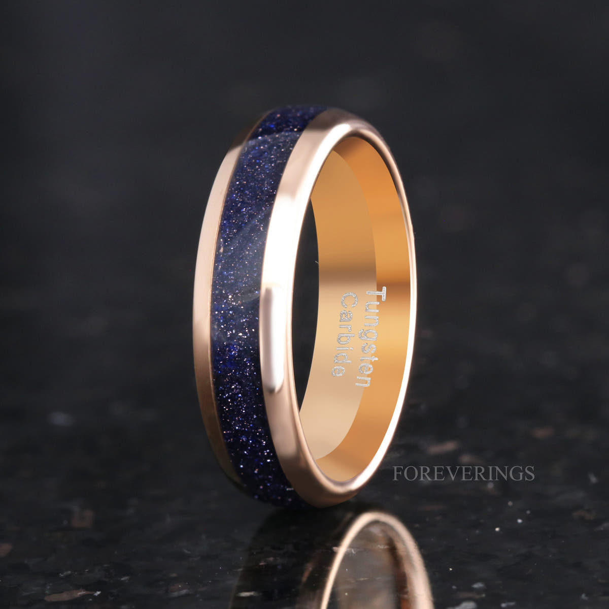 Men's 6mm rose gold tungsten band with Great Rift blue sandstone inlay, angled to show the interior