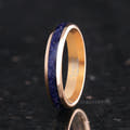 Women's 4mm rose gold tungsten ring with blue sandstone inlay, standing upright