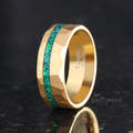 Men's 8mm hammered gold tungsten ring with a green emerald fire opal stripe, angled view