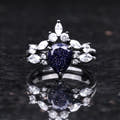 Women's black sterling silver bridal set with pear blue sandstone and a marquise crown band, front view