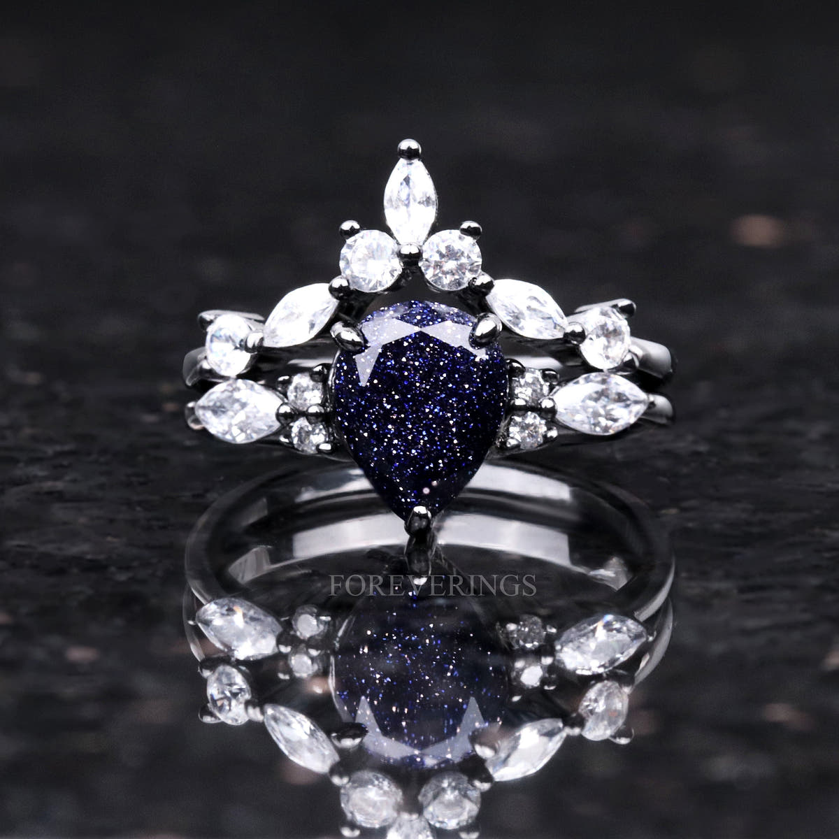 Women's black sterling silver bridal set with pear blue sandstone and a marquise crown band, front view
