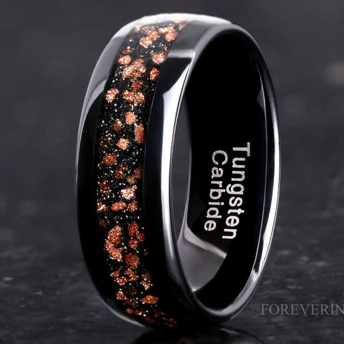 8mm black tungsten wedding band with red goldstone inlay, polished dome, close up