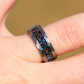 Men's 8mm hammered silver tungsten band with meteorite and galaxy opal worn on a finger