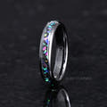 Women's 4mm black ceramic galaxy opal ring standing upright, side angle
