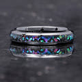 Women's 4mm black ceramic ring with galaxy opal inlay lying flat, front view