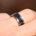 8mm meteorite and galaxy opal band on a finger, side view of the hammered silver edge