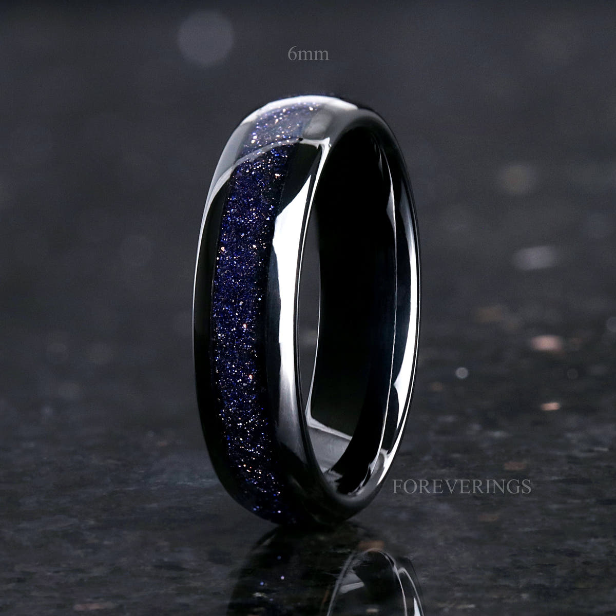 6mm black tungsten ring with blue sandstone inlay standing upright, angled view