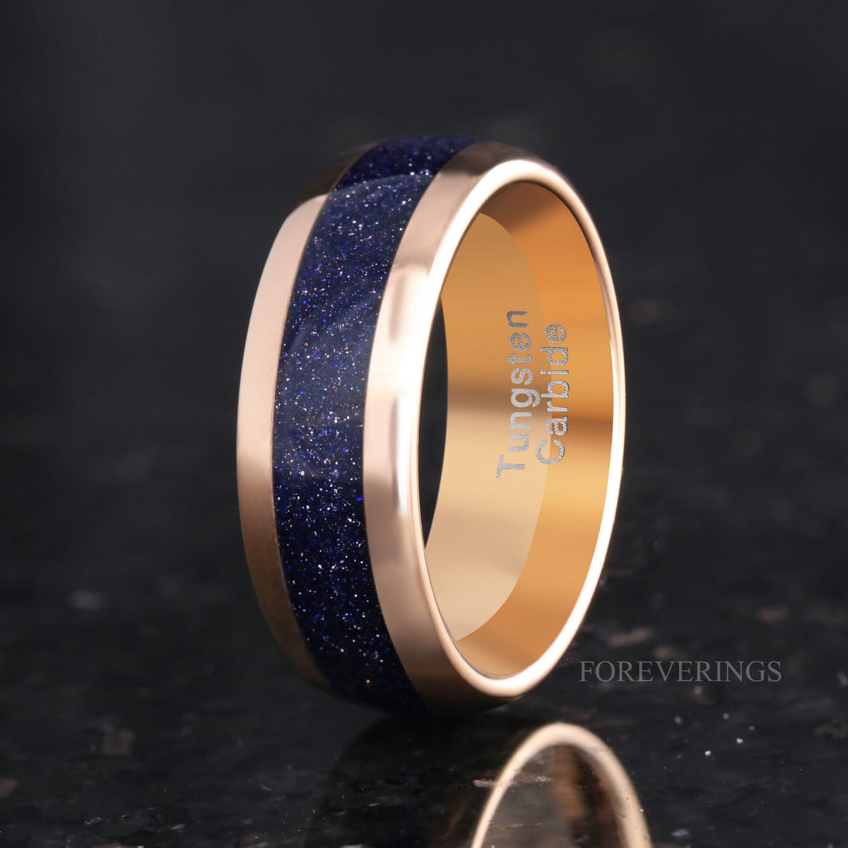 Men's 8mm rose gold tungsten band with blue sandstone inlay, standing at an angle