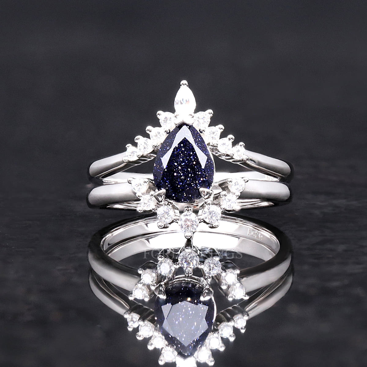Pear-cut blue sandstone bridal set shown straight on in a wider view, reflection below