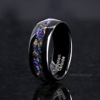 Men's 8mm polished black tungsten ring with crushed moonstone inlay, angled view