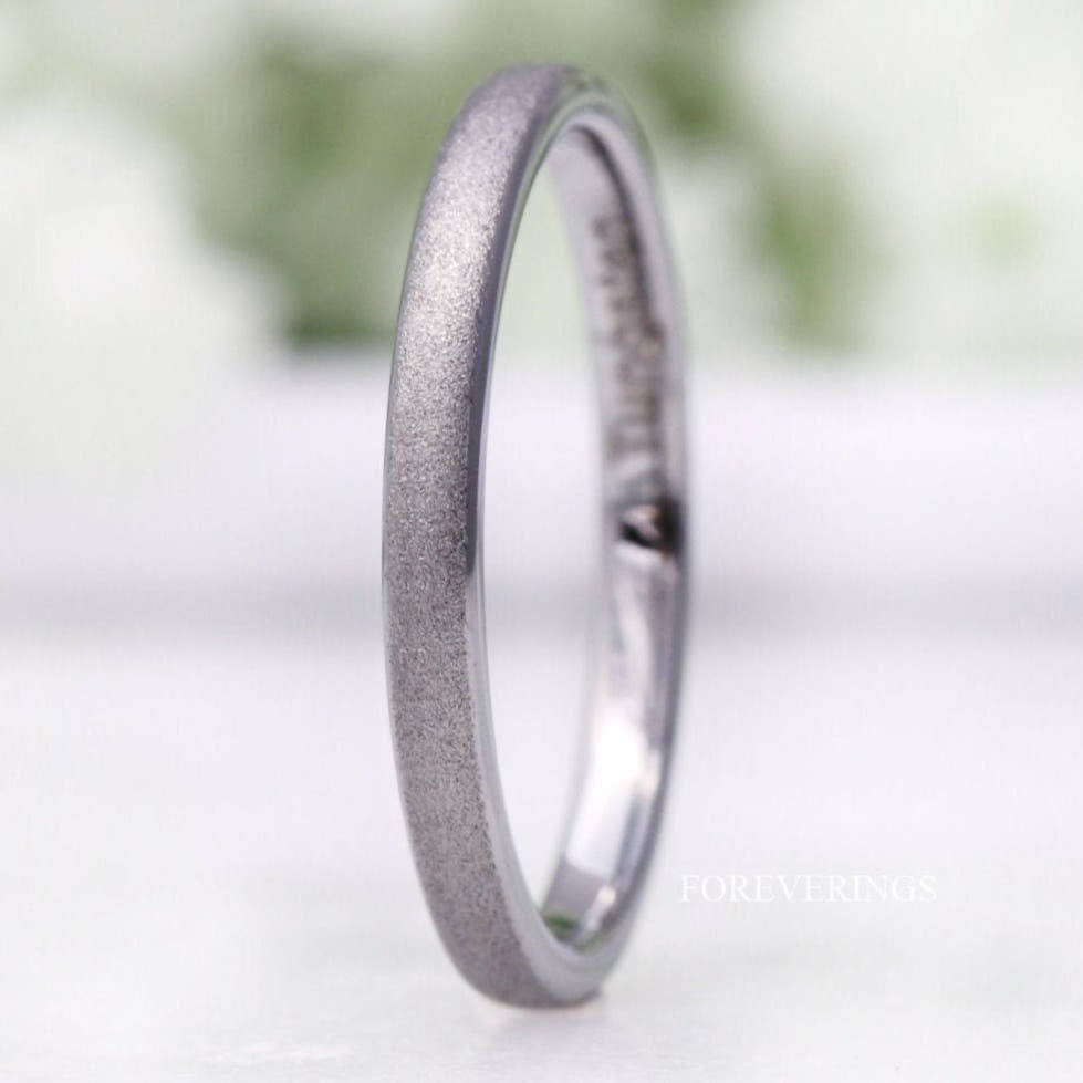 Women's 2mm sandblasted silver tungsten wedding band standing at an angle