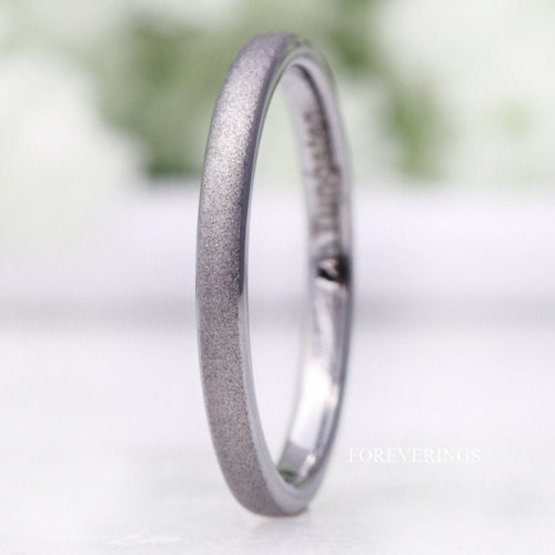 Women's 2mm sandblasted silver tungsten wedding band standing at an angle