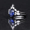 Blue sapphire engagement ring in black sterling silver, angled side view