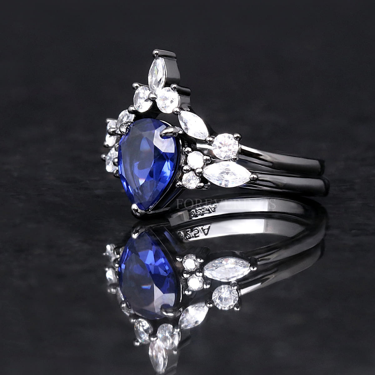 Blue sapphire engagement ring in black sterling silver, angled side view