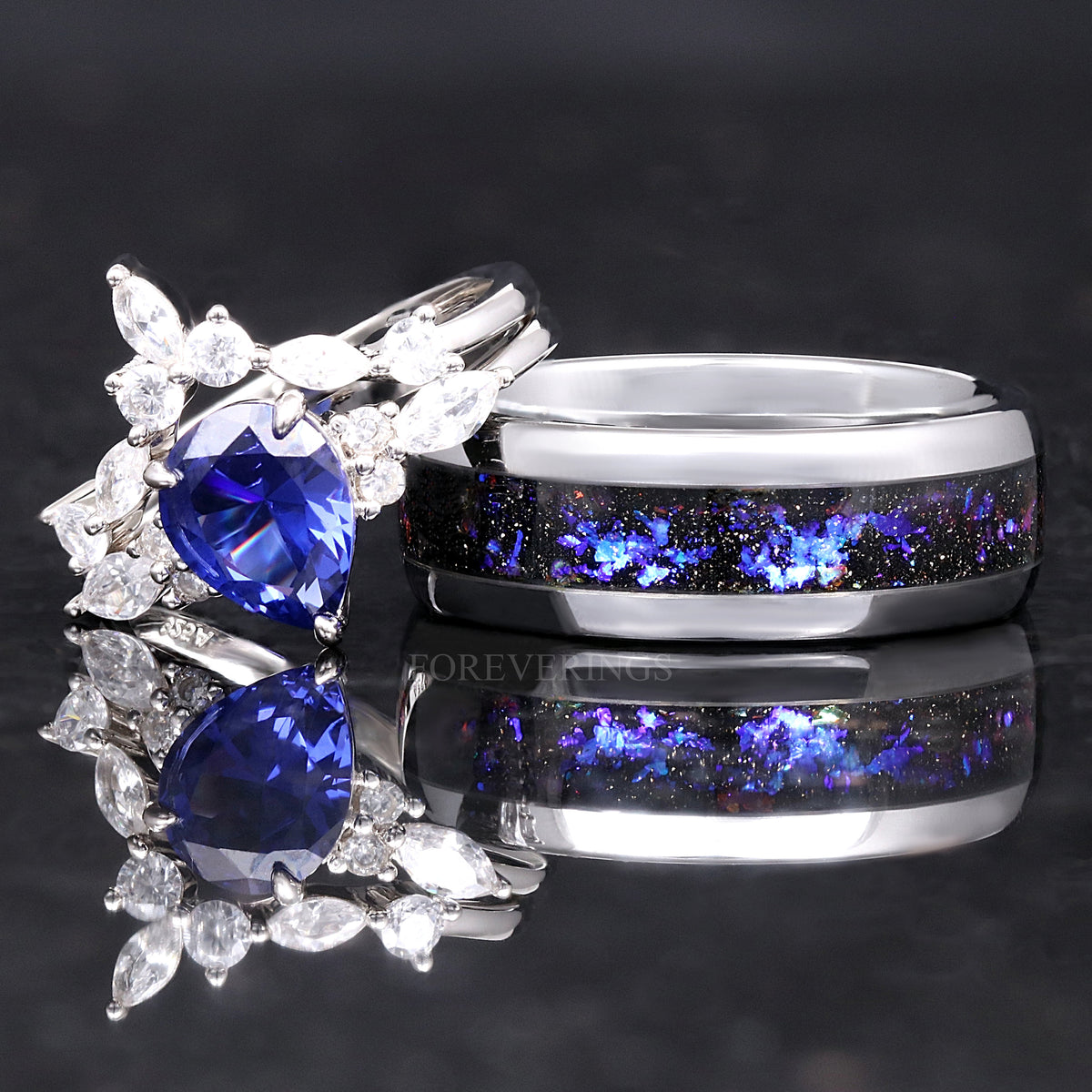 Sapphire bridal set leaning on a wider silver band with nebula inlay
