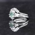 Side view of the women's sterling silver moss agate ring and its accent band