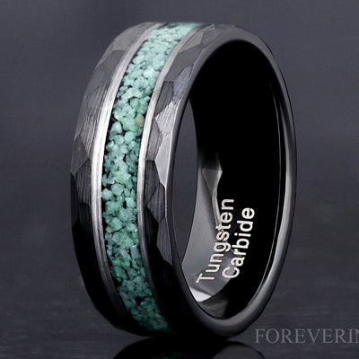 Men's black hammered tungsten wedding band with green moss agate inlay, close crop