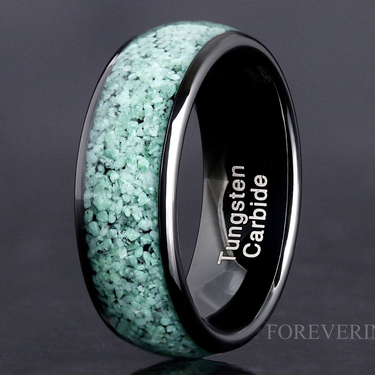 Black tungsten ring with crushed green moss agate inlay, standing close-up showing the interior