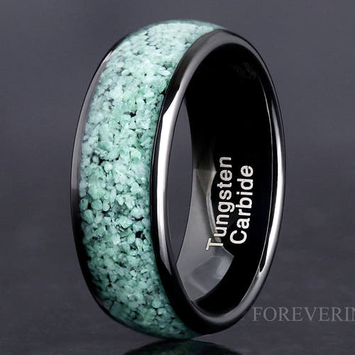 Black tungsten ring with crushed green moss agate inlay, standing close-up showing the interior