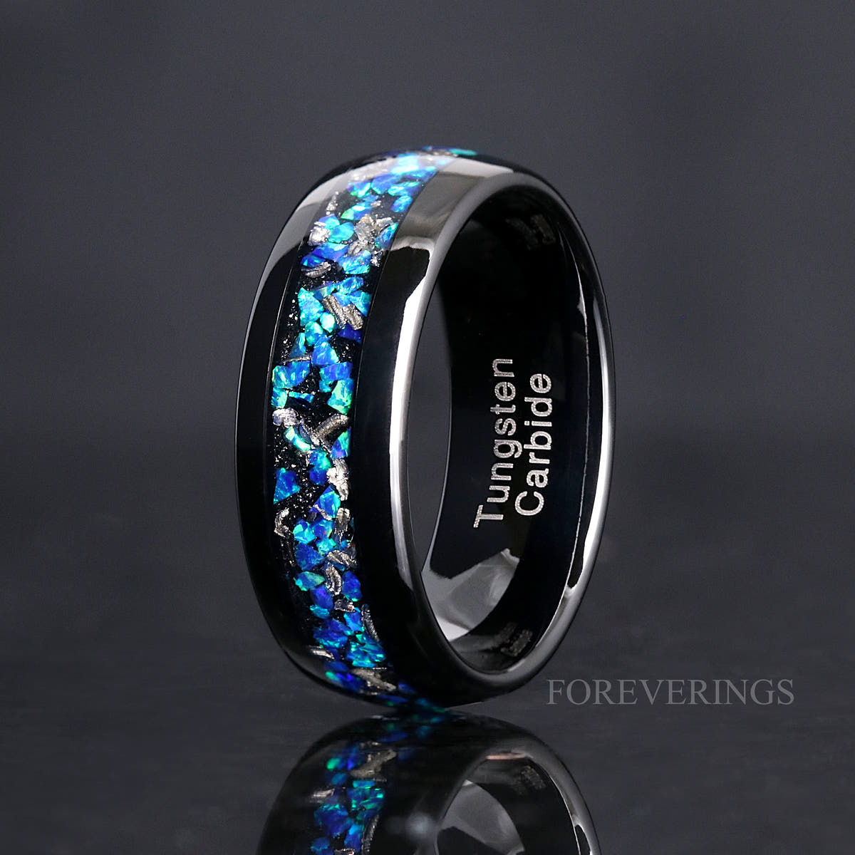 Men's 8mm black tungsten band with meteorite and blue opal inlay, standing to show the interior