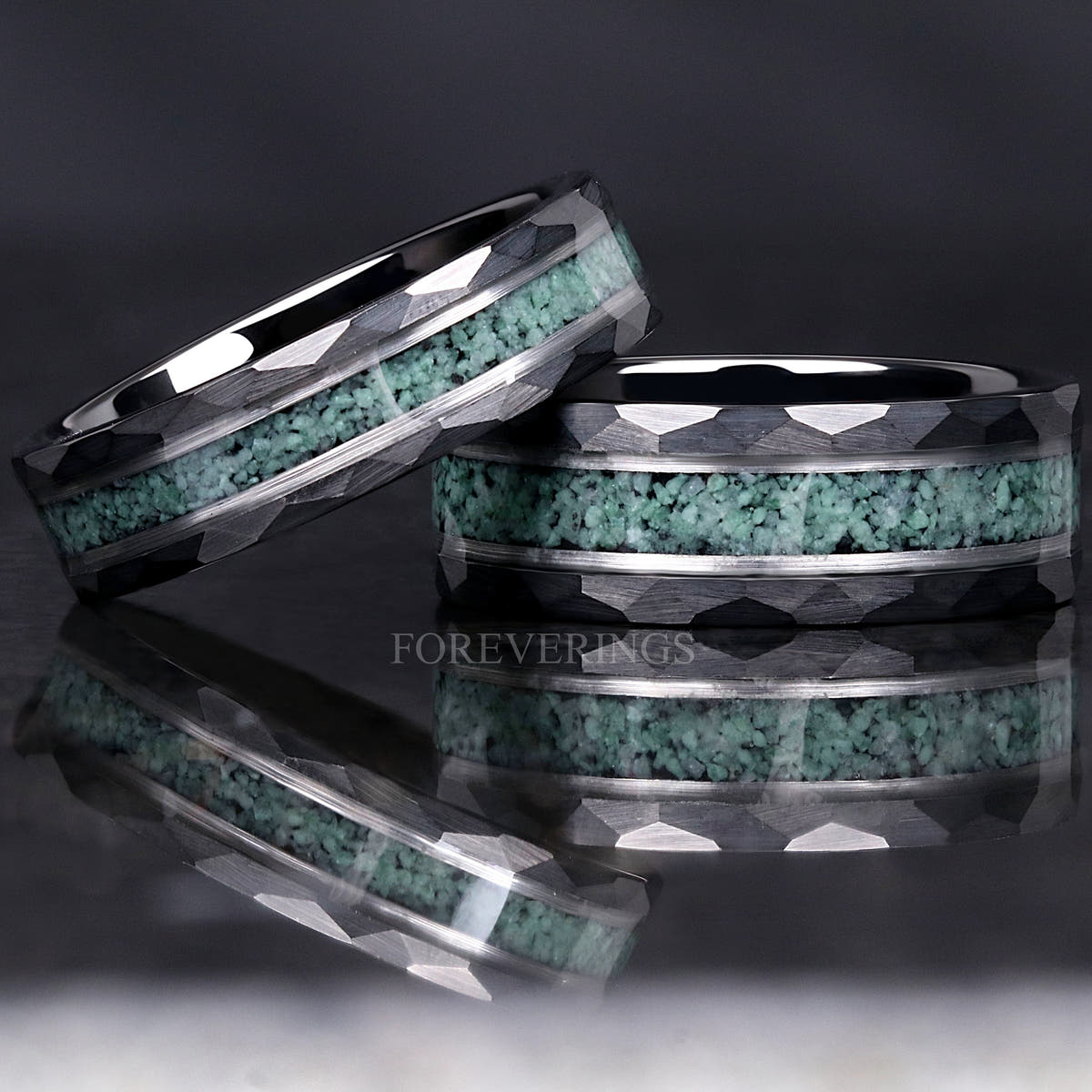 Two widths of the hammered moss agate tungsten band, one leaning on the other