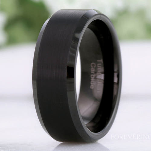 Men's flat matte black tungsten wedding band with beveled edges, standing close-up