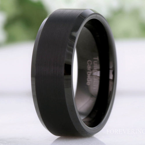Men's flat matte black tungsten wedding band with beveled edges, standing close-up