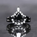 Pear-cut black onyx bridal set in black sterling silver with a curved halo band, front view