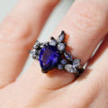 Women's black sterling silver blue sapphire engagement ring worn on a hand