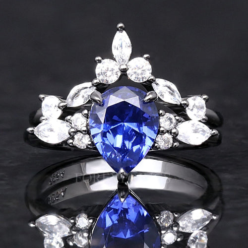 Black sterling silver bridal set with a pear-cut blue sapphire and marquise-cut accents