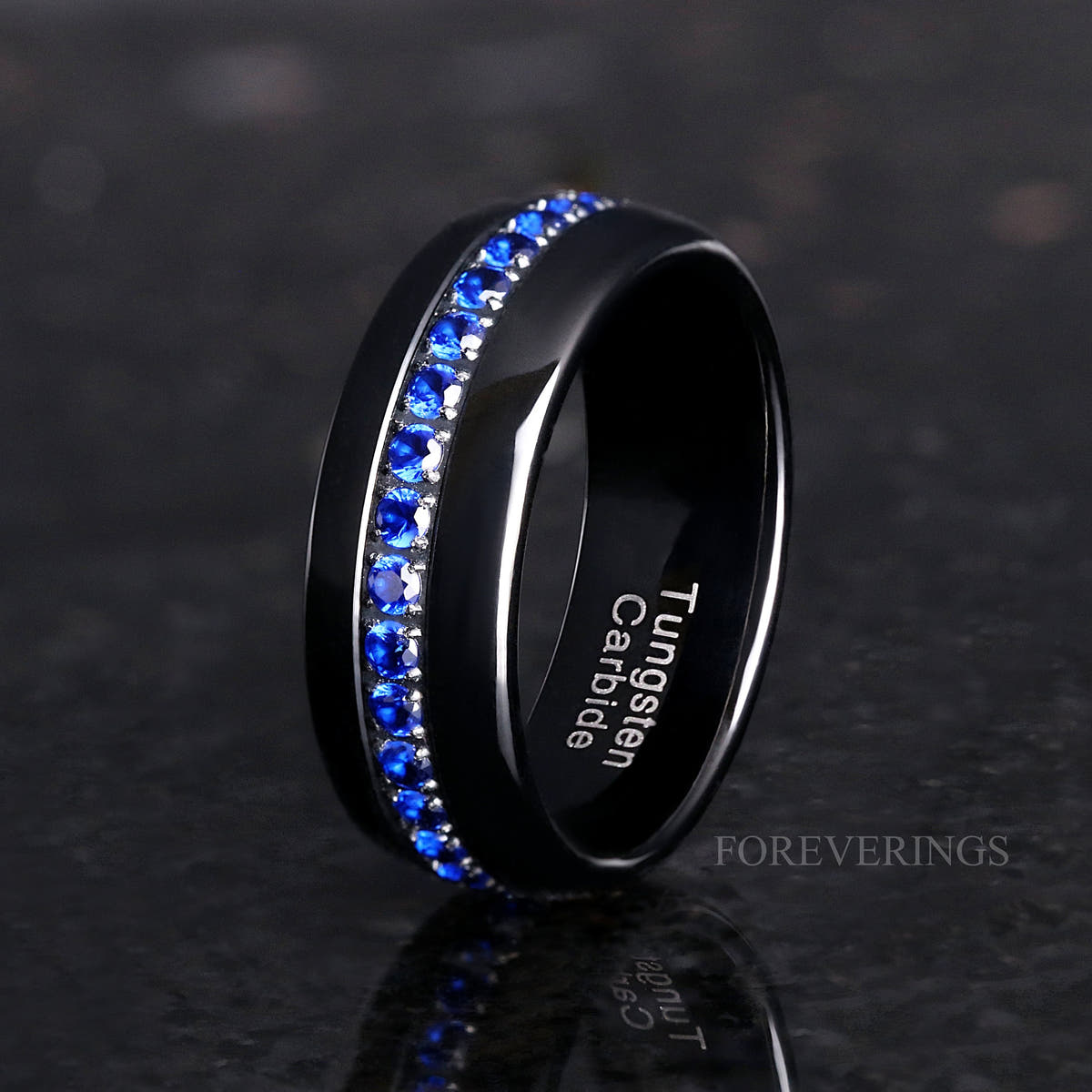 8mm black tungsten wedding band with blue sapphire stones standing at an angle