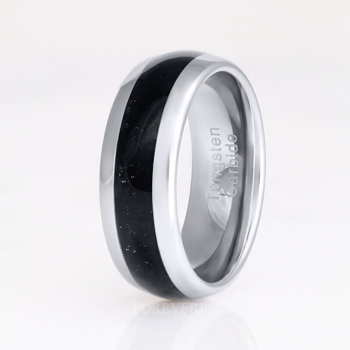 Black onyx ring in silver tungsten standing on edge, wider angled view