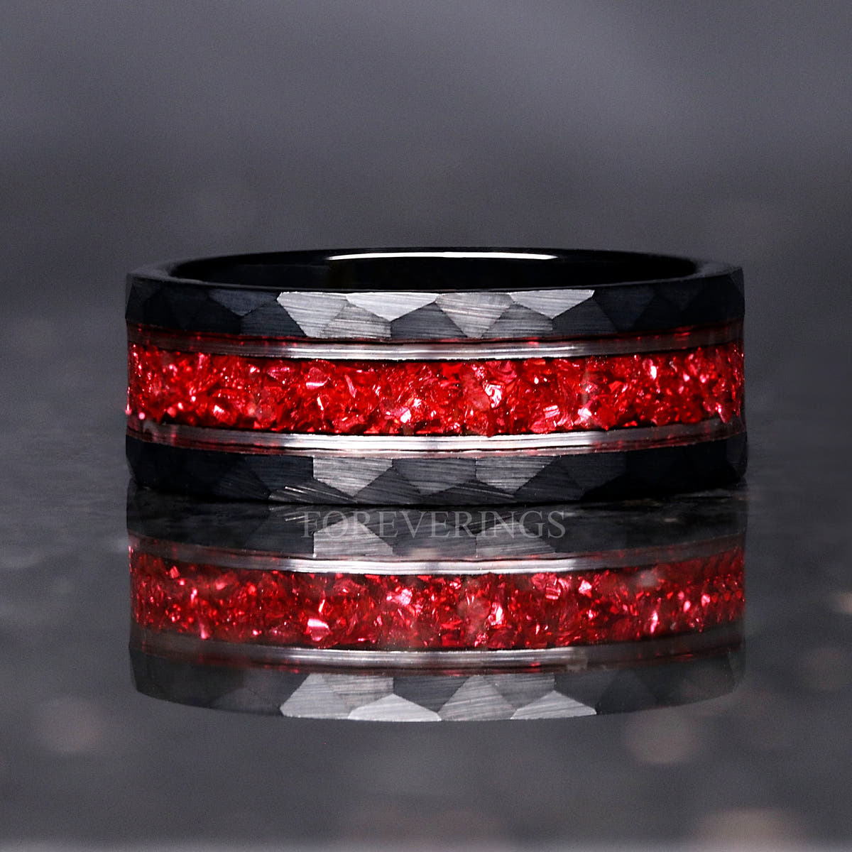 Black hammered tungsten wedding band with crushed ruby inlay and silver stripes, front view