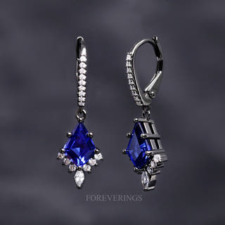 Women's Orion Nebula drop earrings in black sterling silver with kite cut blue sapphires, one turned sideways