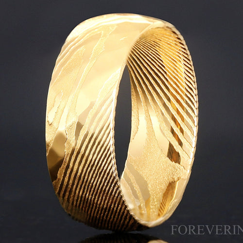 Men's 8mm gold Damascus steel band with a hammered faceted finish, standing at an angle