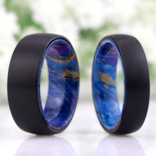 Men's brushed black tungsten band with blue elder wood lining standing beside a second band