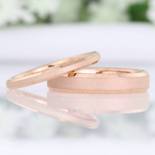 Women's sandblasted rose gold tungsten band in 2mm and 4mm widths, 2mm leaning on 4mm