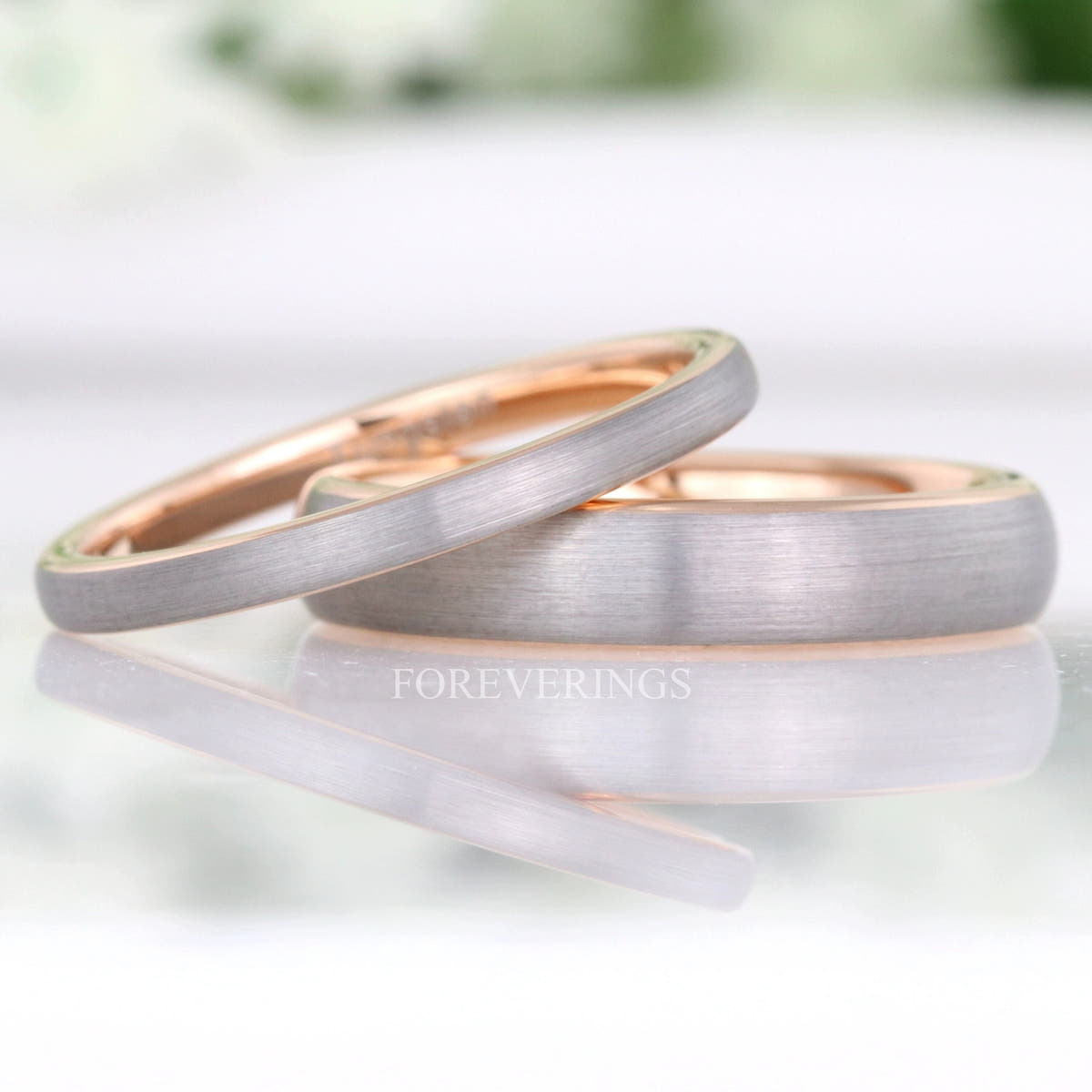 2mm and 4mm brushed silver tungsten bands with rose gold interiors, the two width options together
