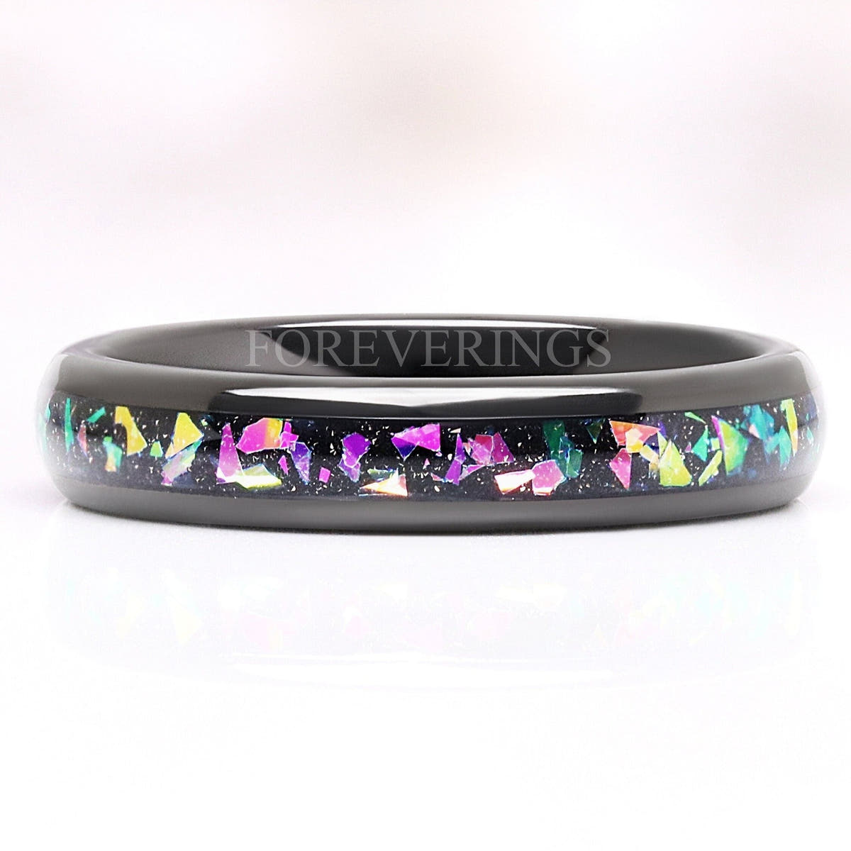 4mm black tungsten wedding band with a multicolor supernova inlay, lying flat front view
